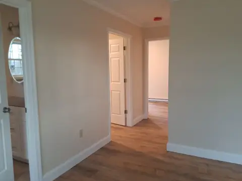 Room with painted walls, a vinyl plank floor and doorways