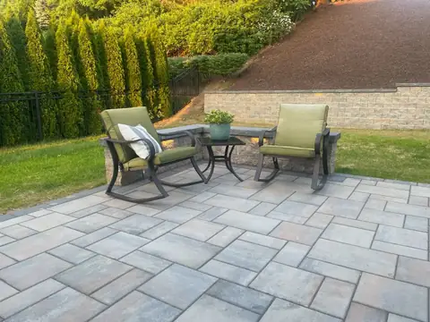 Paver patio with a seat wall and a retaining wall