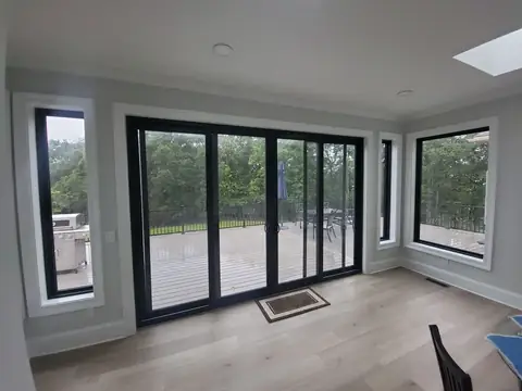 Room with black sliding doors and a skylight