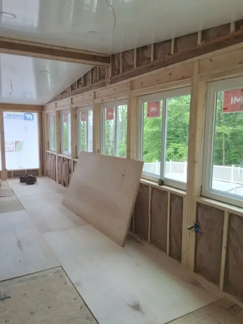 Sunroom interior framing with new windows, during the build