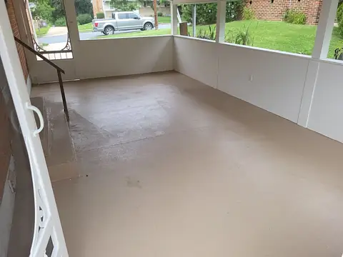 Enclosed porch interior with a gray floor and white knee walls