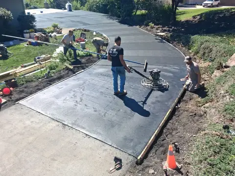 Crew power-troweling a curved section of the driveway