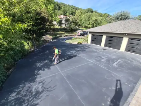 Control joints in a concrete pad in front of a three-bay garage