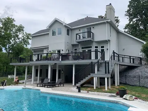 Two-level composite deck with cable railing over a pool