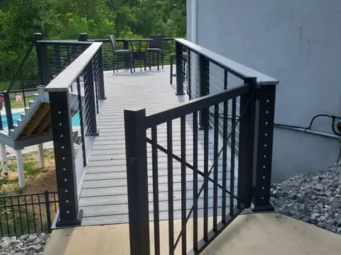 Composite deck walkway with a gate and cable railing