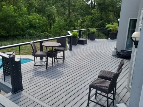 Composite deck with a picture-frame border and cable railing