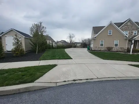 Concrete driveway apron with a curb and lawn edges