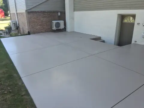 Concrete patio with control joints under deck stairs