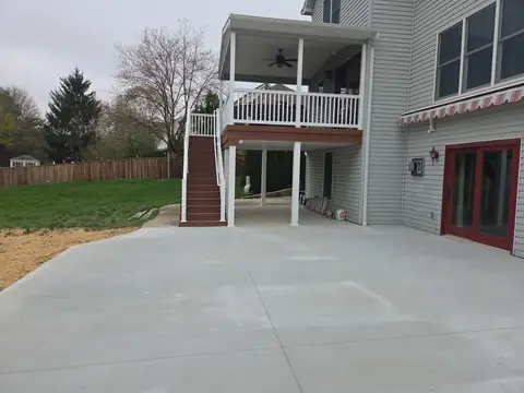 Concrete patio with control joints by deck stairs