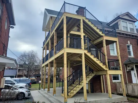 Multi-level wood deck with stairs and black aluminum railing