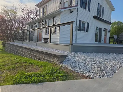Retaining wall with river rock below a composite deck