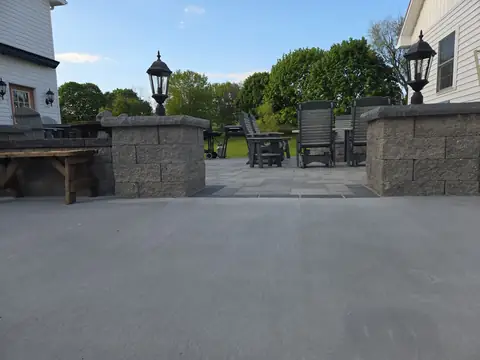 Paver patio with block pillars and lantern lights