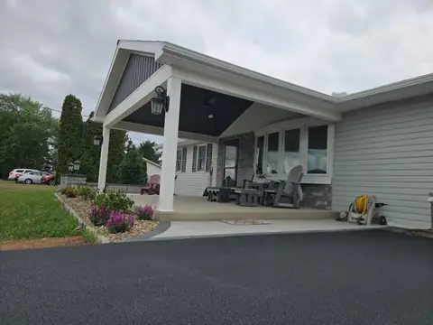 Covered front porch with a gable roof and dark ceiling