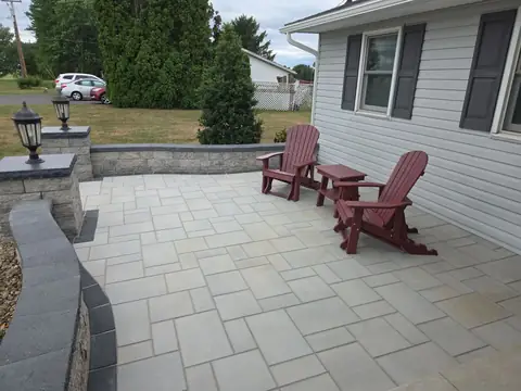 Paver patio with seat walls and lit pillars