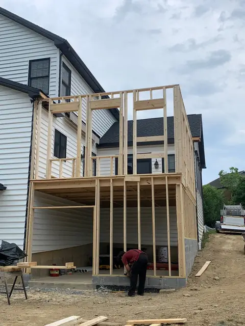 Two-story addition framing at the rear of a house