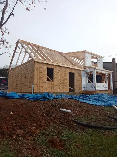 Addition wall framing and roof trusses attached to the house